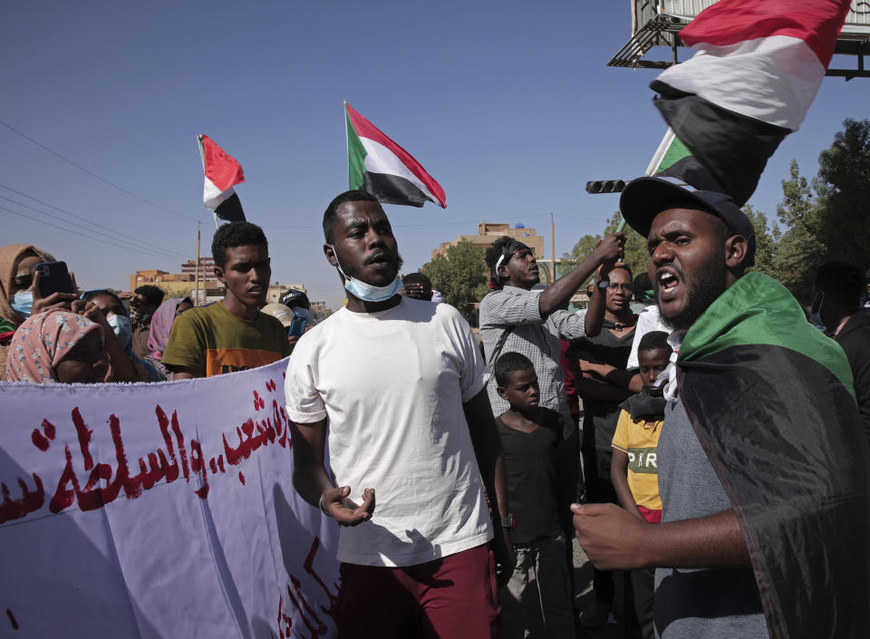 Thousands of protesters take to the streets to renew their demand for a civilian government in the Sudanese capital Khartoum, Thursday, Nov. 25, 2021. The rallies came just days after the military signed a power-sharing deal with the prime minister, after releasing him from house arrest and reinstating him as head of government. The deal came almost a month after the generals orchestrated a coup. Sudan’s key pro-democracy groups and political parties have dismissed the deal as falling short of their demands for a fully civilian rule. (AP Photo/Marwan Ali)