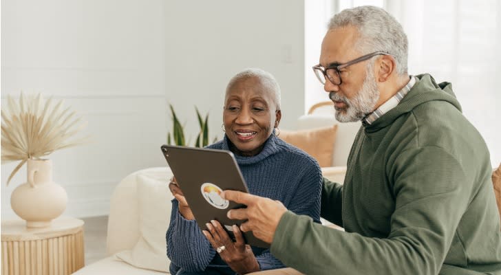 A married couple reviews their investment portfolio together. 