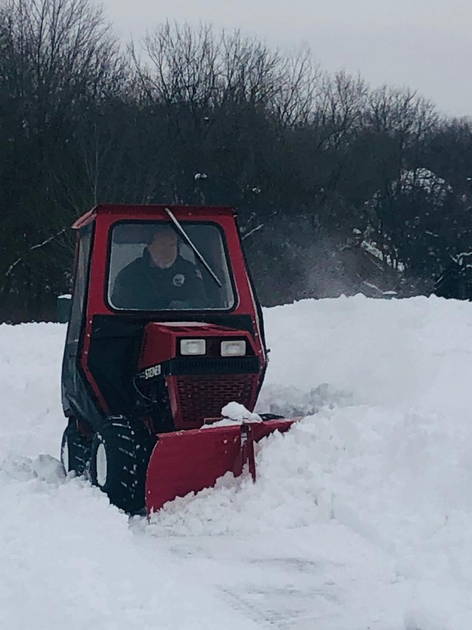 A North Canton City Schools employee plows the walkways outside Northwood Elementary School on Monday.