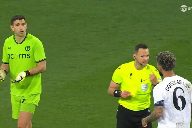 Aston Villa players Douglas Luiz and Emi Martinez speak to the referee