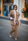 <p>A guest spotted arriving at the Natasha Zinko show in a beige woollen two-piece suit complete with hair barrettes and a Fendi bag. <em>[Photo: Getty]</em> </p>