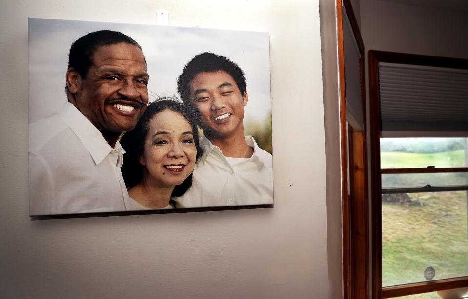 Image: A family portrait of Gareth, Fe and Christian Hall hanging on the wall. (Fred Adams for Spotlight PA and NBC News)