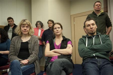 (From L) Greenpeace International activists Sini Saarela of Finland, Ana Paula Alminhana Maciel of Brazil and Tomasz Dziemianczuk of Poland await the decision by the Russian Parliament, in this December 18, 2013 handout from Greenpeace. REUTERS/Dmitri Sharomov/Greenpeace/Handout via Reuters