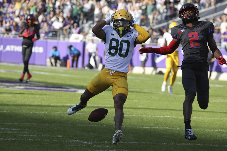 Baylor wide receiver Monaray Baldwin (80) reacts after a dropped pass while defended by TCU cornerback Josh Newton (2) in the first half of an NCAA college football game, Saturday, Nov. 18, 2023, in Fort Worth, Texas. (Rod Aydelotte/Waco Tribune-Herald via AP)