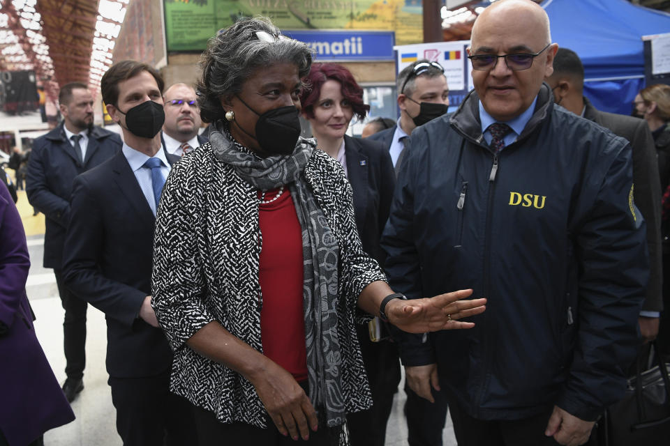 Linda Thomas-Greenfield, United States ambassador to the United Nations gestures next to the head of Romania's Department for Emergency Situations (DSU) Raed Arafat during a visit to a help center that is assisting refugees fleeing the war from neighbouring Ukraine, in Gara de Nord, the main railway station, in Bucharest, Romania, Monday, April 4, 2022. (Alex Micsik /Pool Photo via AP)