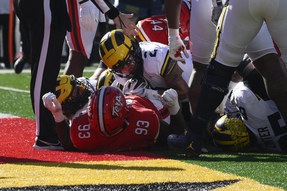 Michigan running back Blake Corum (2) scores a touchdown against Maryland defensive lineman Tre Colbert (93) during the first half of an NCAA college football game, Saturday, Nov. 18, 2023, in College Park, Md. (AP Photo/Nick Wass)