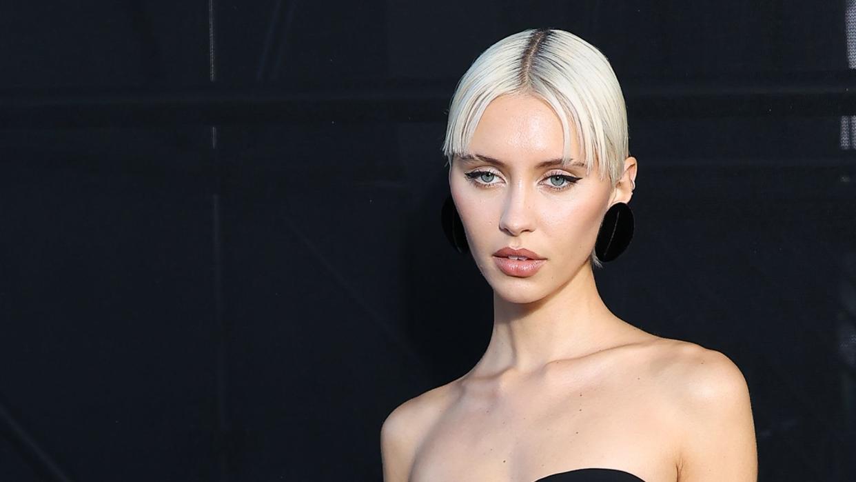 Iris Law attends the Saint Laurent Womenswear Spring/Summer 2024 show in a skintight all-black ensemble