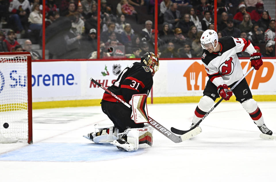 New Jersey Devils right wing Nathan Bastian (14) watches the puck enter the net on his shot on Ottawa Senators goaltender Anton Forsberg (31) during first period of an NHL hockey game in Ottawa, on Saturday, Nov. 19, 2022. (Justin Tang /The Canadian Press via AP)