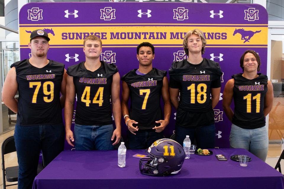 Players from the Sunrise Mountain High School football team pose for a photo during the Peoria district football media day at the Liberty Buick showroom in Peoria on Aug. 2, 2023.