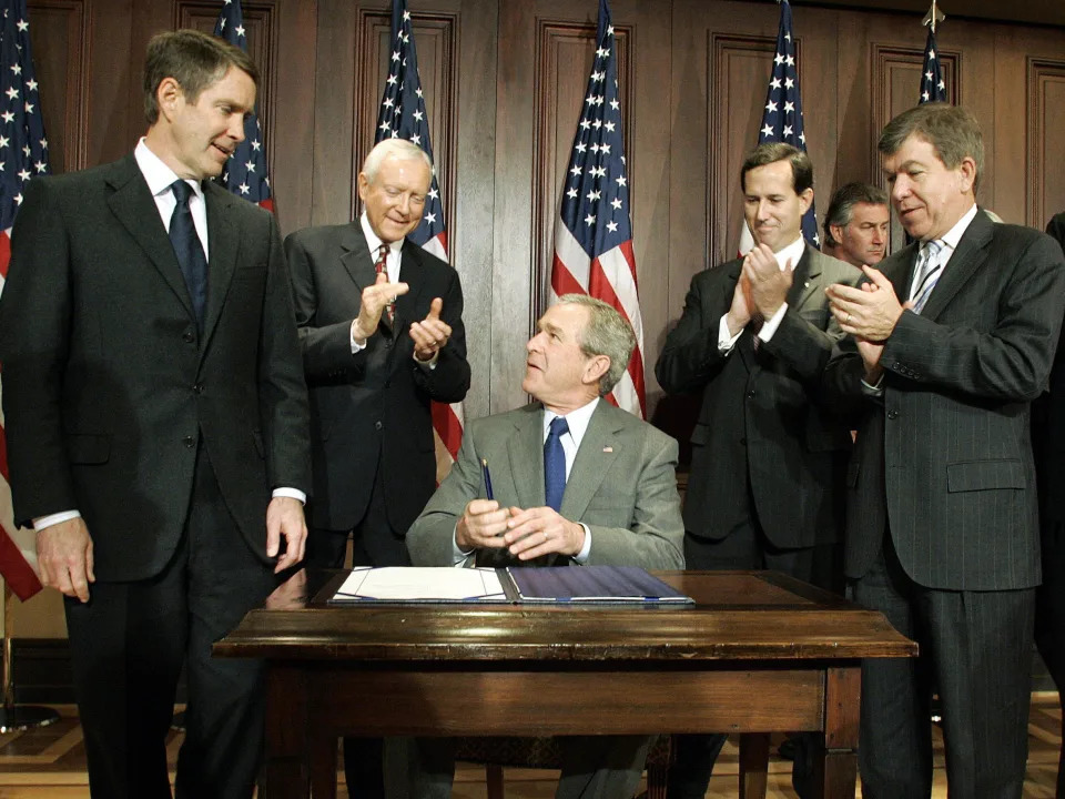 Former President George W. Bush is applauded for signing the Protection of Lawful Commerce Arms Act in 2005.