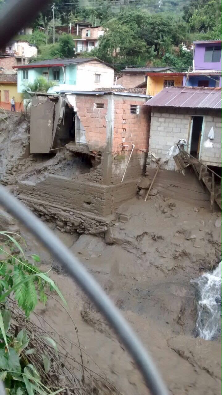 Damaged homes and a street covered in mud and debris are seen in the municipality of Salgar, in Antioquia department after a landslide in this May 18, 2015 handout image provided by Colombian Air Force. A landslide sent mud and water crashing onto homes in a town in Colombia's northwest mountains on Monday, killing at least 48 people and injuring dozens, officials said. Heavy rains caused a ravine to overflow, sending mud and water onto neighboring homes in Salgar. REUTERS/Colombian Air Force/Handout via Reuters ATTENTION EDITORS - THIS PICTURE WAS PROVIDED BY A THIRD PARTY. REUTERS IS UNABLE TO INDEPENDENTLY VERIFY THE AUTHENTICITY, CONTENT, LOCATION OR DATE OF THIS IMAGE. FOR EDITORIAL USE ONLY. NOT FOR SALE FOR MARKETING OR ADVERTISING CAMPAIGNS. THIS PICTURE IS DISTRIBUTED EXACTLY AS RECEIVED BY REUTERS, AS A SERVICE TO CLIENTS.