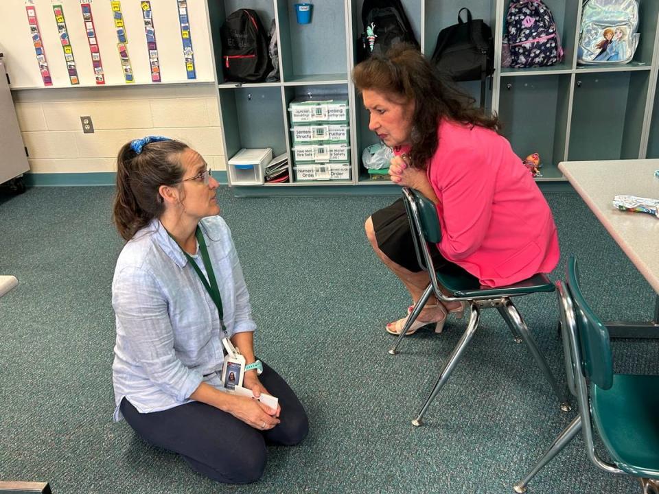 Jenn Botterell (left), a special-education teacher assistant at Riverwood Elementary School in Clayton, N.C., talks to state Rep. Donna White (right) on May 15, 2023. It was a statewide Bring Your Legislator To School Day.
