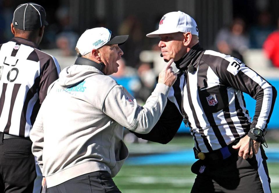 Carolina Panthers interim head coach Chris Tabor, left, speaks with referee Clete Blakeman, right, during action against the Tampa Bay Buccaneers at Bank of America Stadium in Charlotte, NC on Sunday, January 7, 2024. The Buccaneers defeated the Panthers 9-0.