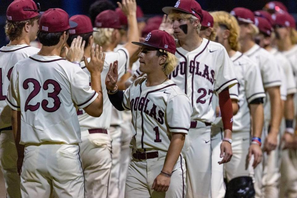 Marjory Stoneman Douglas pitcher Luke Cherry (1) reacts with teammates after defeating Columbus 8-6 during a high school baseball game at Columbus High School in Miami, Florida, on Friday, March 24, 2023.