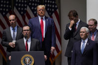 President Donald Trump listens as Treasury Secretary Steven Mnuchin speaks during a news conference in the Rose Garden of the White House, Friday, June 5, 2020, in Washington. (AP Photo/Evan Vucci)