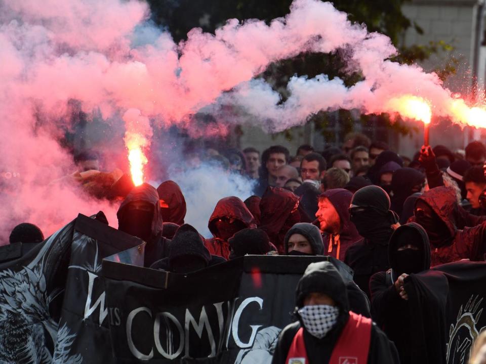 Protesters against Emmanuel Macron’s reforms stage a demonstration with banners and road flares in Nantes (AFP/Getty)