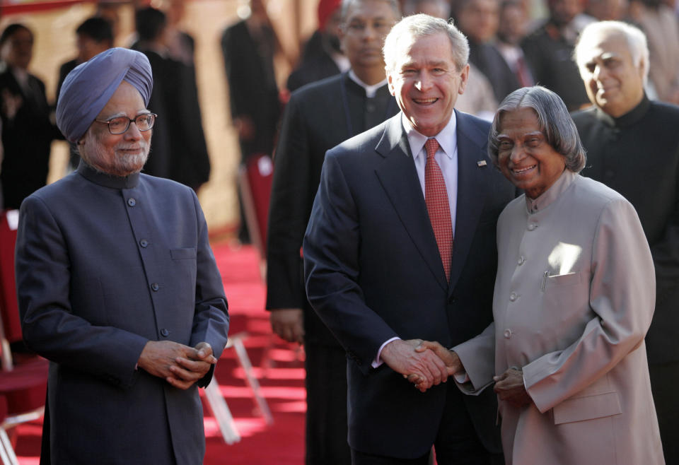 U.S. President George W. Bush shakes hands with Indian President A.P.J. Abdul Kalam while Prime Minister Manmohan Singh looks on during an official welcoming ceremony at the Presidential Palace in New Delhi on March 2, 2006. | Emmanuel Dunand–AFP/Getty Images