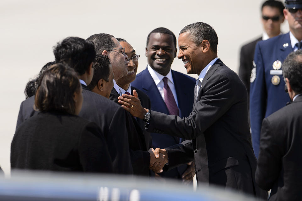 President Barack Obama shakes hands with Fulton County, Ga., Chairman John Eaves as Dekalb County, Ga., CEO Burrell Ellis and Atlanta Mayor Kasim Reed look on, upon Obama's arrival on Air Force One at Hartsfield-Jackson Atlanta International Airport, Tuesday, June 26, 2012, in Atlanta. (AP Photo/Paul Abell)