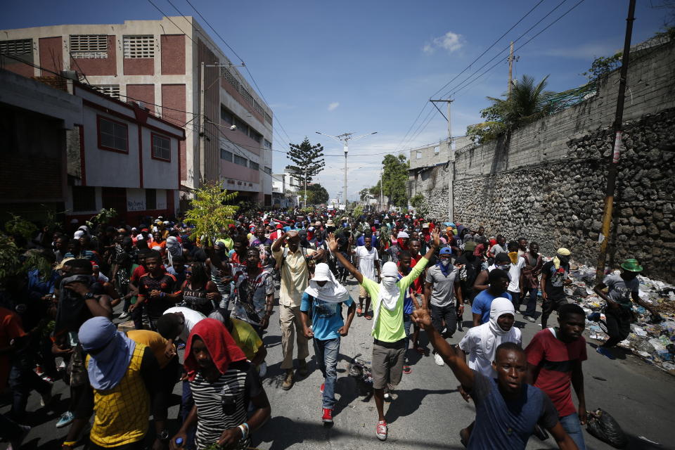 Haitians respond to a nationwide push to block streets and paralyze the country's economy as they press for President Jovenel Moise to give up power, in Port-au-Prince, Haiti, Monday, Sept. 30, 2019. Opposition leaders and supporters say they are angry about public corruption, spiraling inflation and a dwindling supply of gasoline that has forced many gas stations in the capital to close as suppliers demand the cash-strapped government pay them more than $100 million owed. (AP Photo/Rebecca Blackwell)