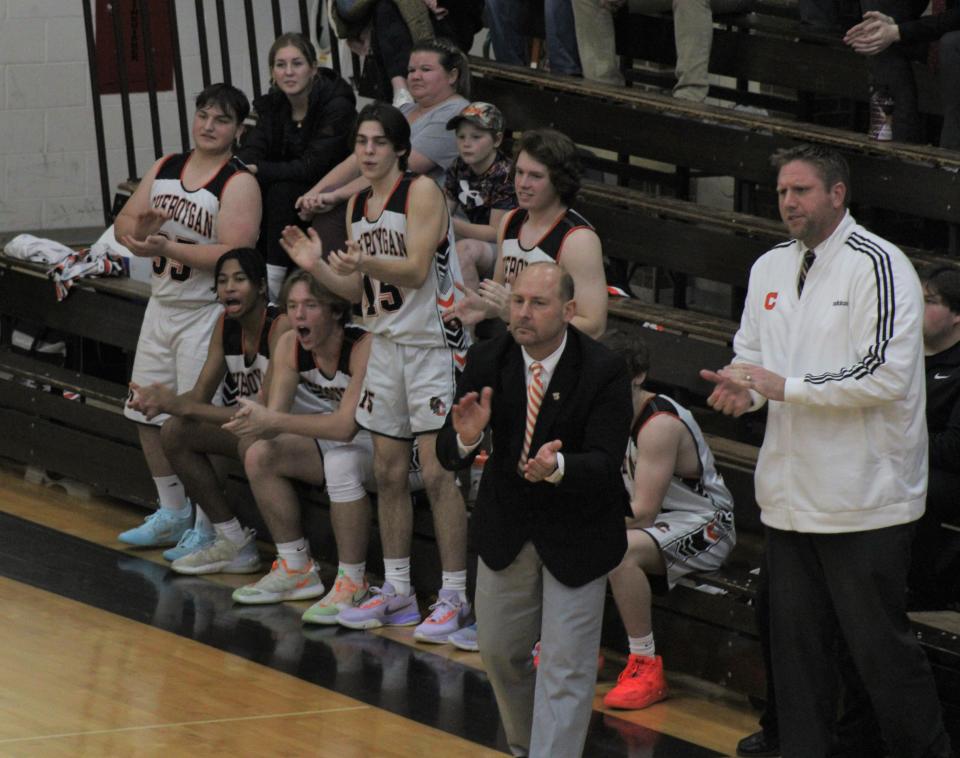 Cheboygan players and coaches celebrate a basket scored during the first half against Ogemaw on Tuesday.