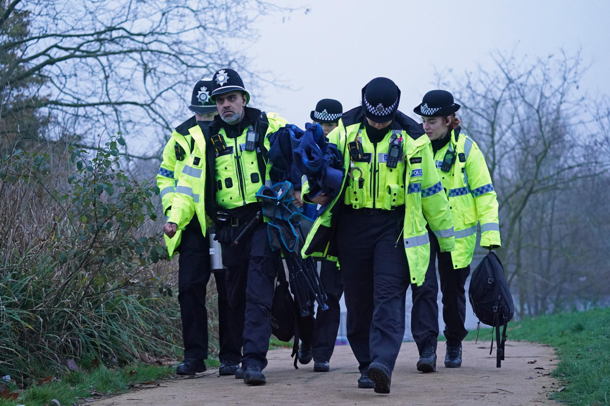 Police officers at the scene in Babbs Mill Park in Kingshurst, Solihull. Four children are in critical condition in hospital after being pulled from an icy lake in cardiac arrest, while a search operation continues amid fears two more children were involved in the incident. Picture date: Monday December 12, 2022.