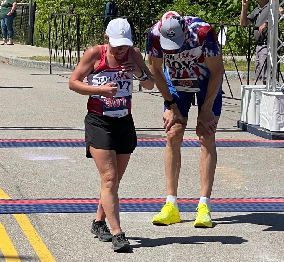 Becca Pizzi, left, and Zdeno Chara catch their breath after finishing the Dick Hoyt Memorial Race at Marathon Elementary School on May 27, 2023.