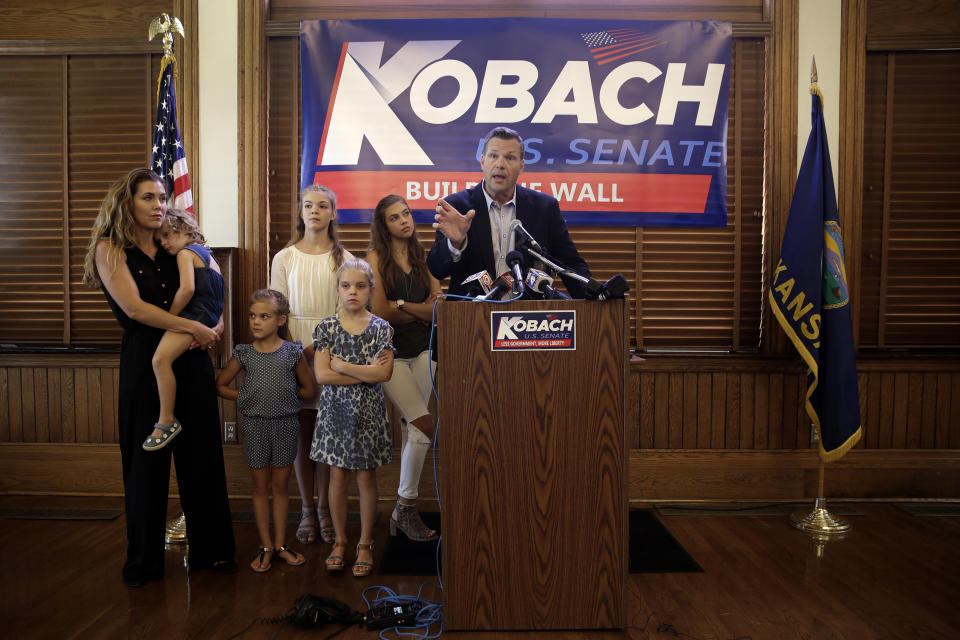 Flanked by family members, former Kansas Secretary of State Kris Kobach announces his candidacy for the Republican nomination for the U.S. Senate Monday, July 8, 2019, in Leavenworth, Kan. (AP Photo/Charlie Riedel)