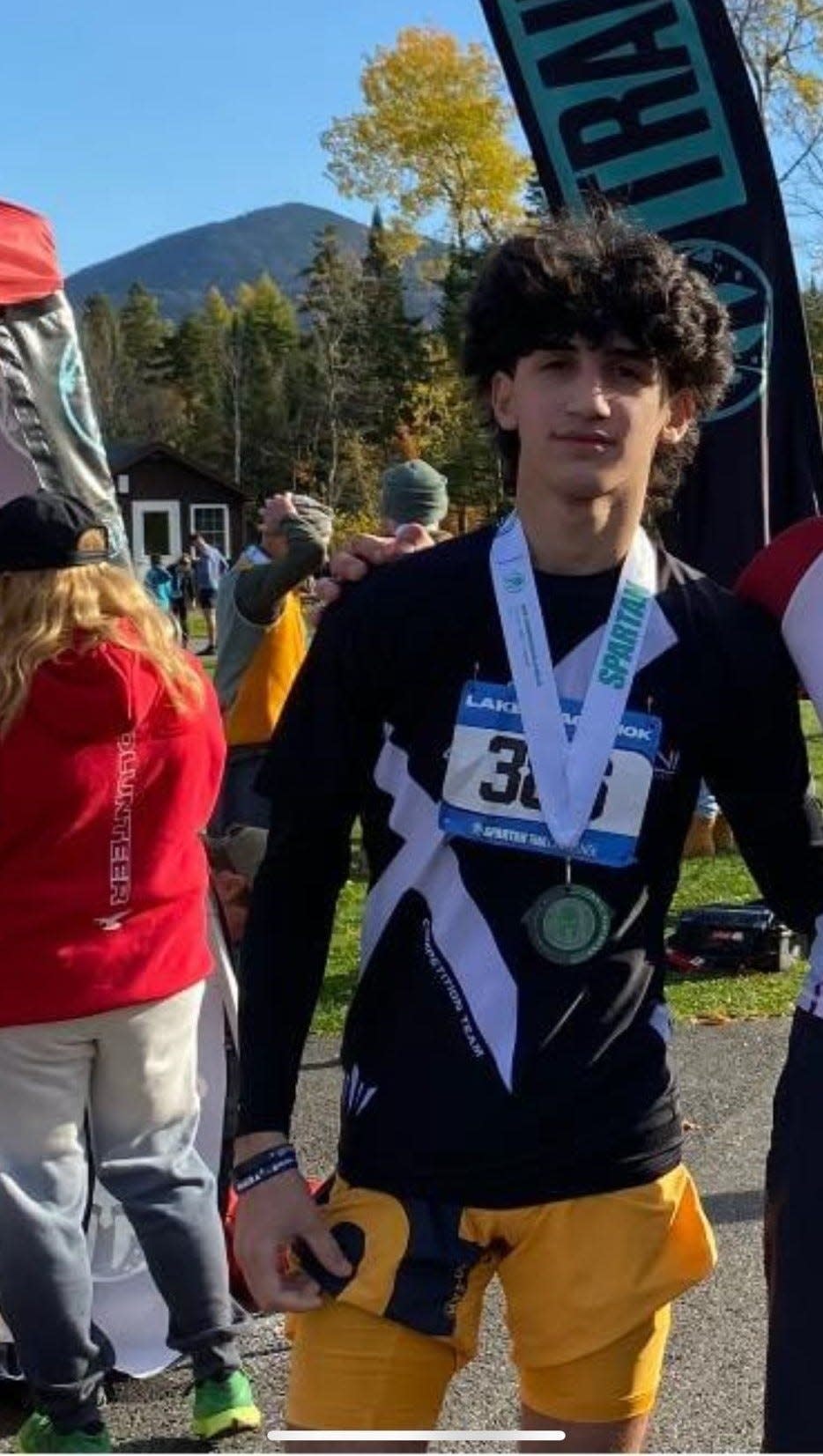 One of John Saleh's favorite photos of his son Ahmad, standing with his medal after finishing a Spartan Race with his brother. Ahmad was killed in a crash on March 13, 2024.