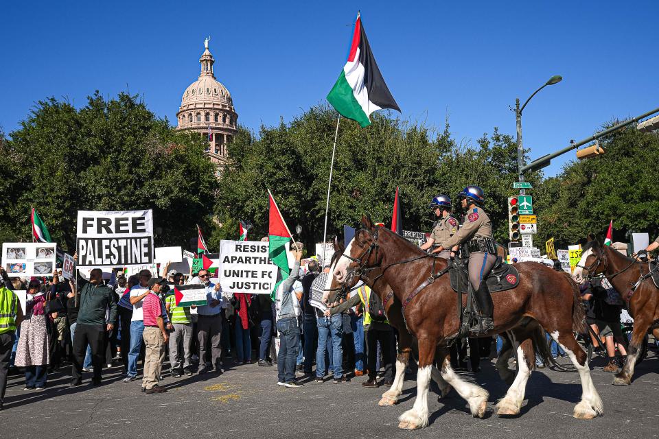 Texas State Troopers on horseback patrol around a solidarity rally for Palestine outside the Texas Capitol on Sunday, Oct. 15, 2023.