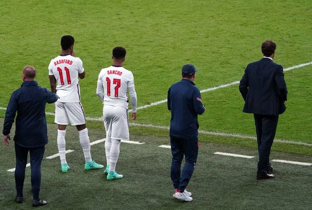 Marcus Rashford, left, and Jadon Sancho wait to come on ahead of Sunday night's shoot-out