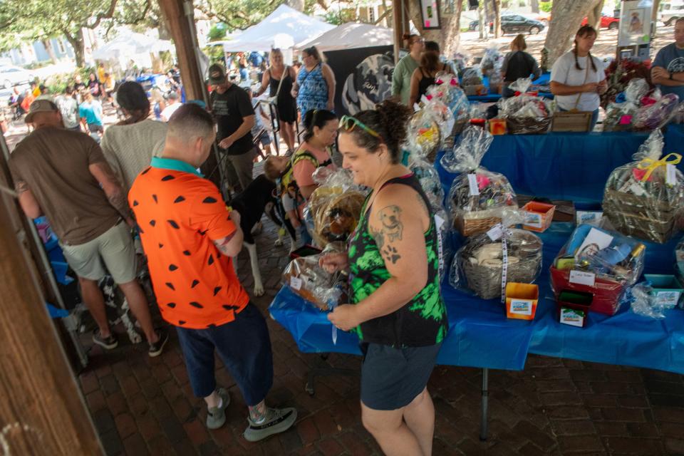 Attendees check out the festivities during the Northwest Florida Great Dane Rescue 's 7th annual Danetoberfest Saturday, October 7, 2023 at Seville Square. The fest included Great Dane adoption, live music, food and vendors.