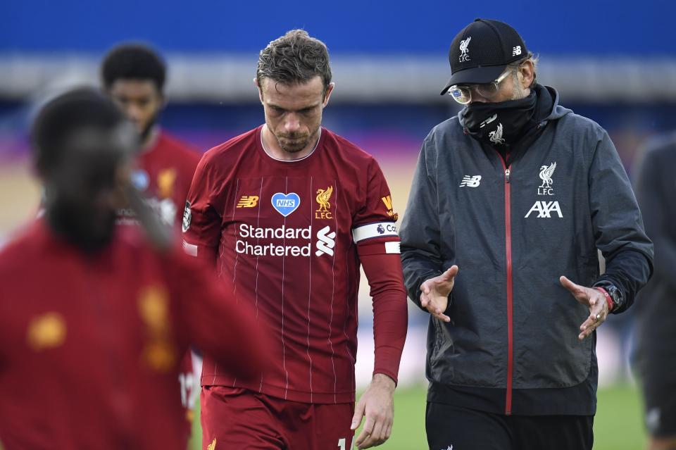 Liverpool's manager Jurgen Klopp and Liverpool's Jordan Henderson leave the field at the end of the English Premier League soccer match between Everton and Liverpool at Goodison Park in Liverpool, England, Sunday, June 21, 2020. (Peter Powell/Pool via AP)