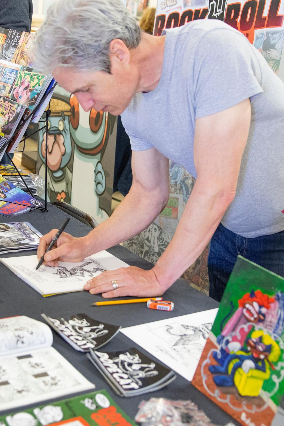 Mike Boheem, from Berkley draws a new sketch of his character Dopecat at the Lodi Comic Con at Lodi Grape Festival on May 8th. Dianne Rose/For The Record