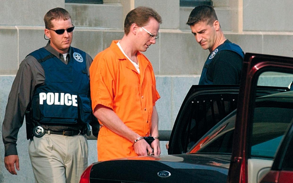  Dustin Honken is led by federal marshals to a waiting car after the second day of jury selection during his 2004 trial  - Time Hynds/Sioux City Journal