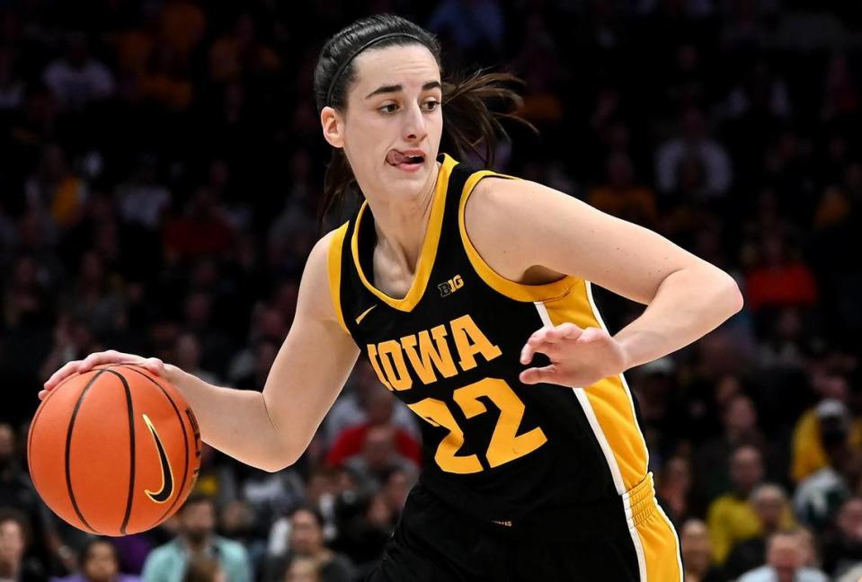 Iowa’s Caitlin Clark bites down on her tongue as she begins to push the ball inside against Virginia Tech during first-half action on Thursday, November 9, 2023 at Spectrum Center in Charlotte, NC.