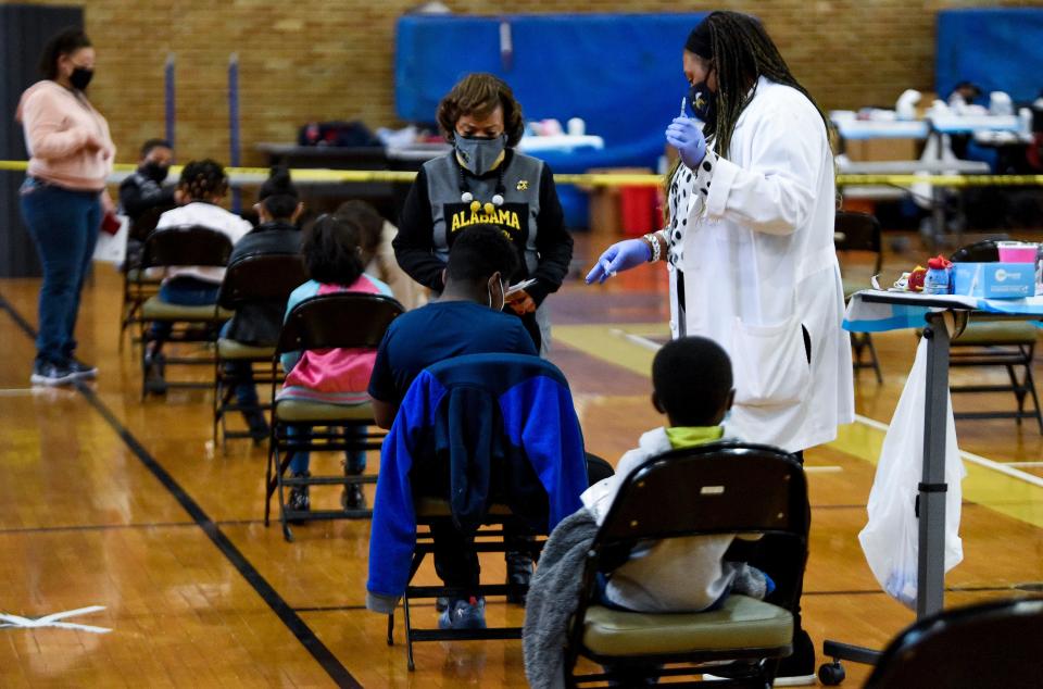 Denice Vaughn and Nurse Practitioner Ashley Tippins give COVID-19 vaccines during a Vaccine Clinic for students, aged 5-11, on the ASU campus in Montgomery, Ala., on Friday January 21, 2022. The clinic was put on in partnership between Alabama State University, Montgomery Public Schools and the Alabama Department of Public Health. 