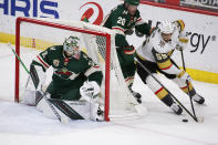 Vegas Golden Knights right wing Keegan Kolesar (55) brings the puck around the goal as Minnesota Wild's Ryan Suter (20) and goaltender Cam Talbot (33) defend during the first period of an NHL hockey game, Wednesday, May 5, 2021, in St. Paul, Minn. (AP Photo/Andy Clayton-King)