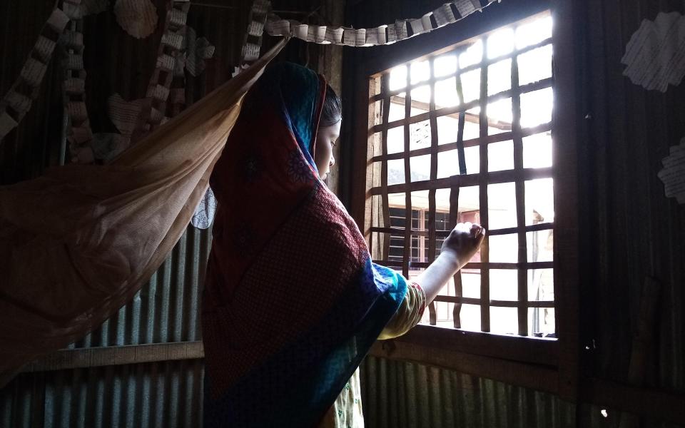 12-year-old Kabita looks out of her window -  Apolo Das