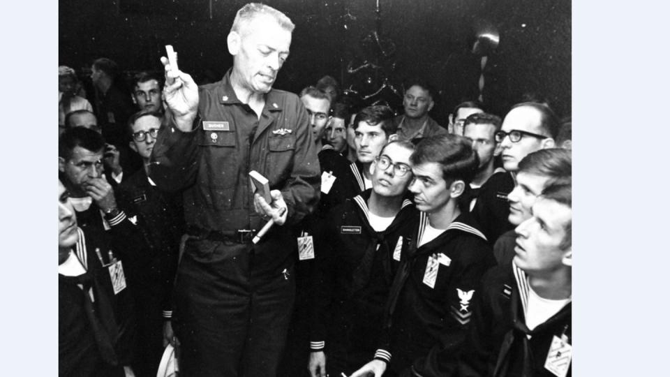 Cmdr. Lloyd M. Bucher, the commanding officer of the spy ship Pueblo, talks with his released crew at the Balboa Naval Hospital on Christmas in 1968. (National Archives)