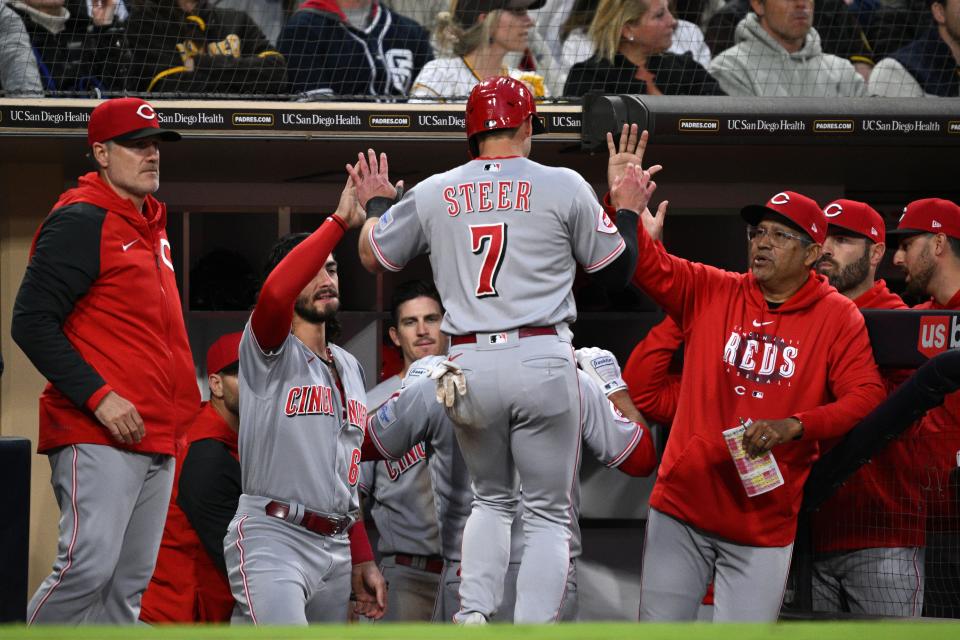 May 1, 2023; San Diego, California, USA; Cincinnati Reds first baseman Spencer Steer (7) is congratulated at the dugout after scoring a run on a two-RBI double hit by left fielder Stuart Fairchild (not pictured) during the third inning against the San Diego Padres at Petco Park. Mandatory Credit: Orlando Ramirez-USA TODAY Sports 