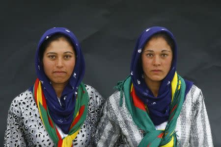 Two Kurdish sisters pose for a picture as they arrive for a gathering celebrating Newroz in Diyarbakir March 21, 2015. REUTERS/Umit Bektas