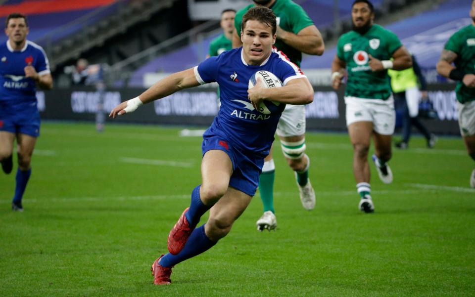France's Antoine Dupont runs in to score his sides first try during the 6 Nations match - PA