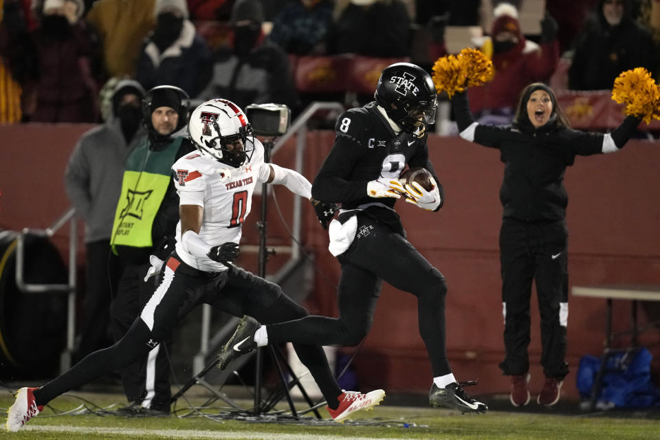 Iowa State wide receiver Xavier Hutchinson (8) runs from Texas Tech defensive back Rayshad Williams (0) after catching a pass during the first half of an NCAA college football game, Saturday, Nov. 19, 2022, in Ames, Iowa. (AP Photo/Charlie Neibergall)