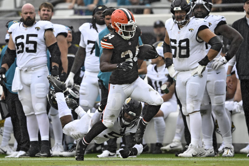 Cleveland Browns running back Jerome Ford (34) slips past Jacksonville Jaguars safety Andre Cisco (5) on a run during the first half of an NFL football game Sunday, Sept. 15, 2024, in Jacksonville, Fla. (AP Photo/Phelan M. Ebenhack)