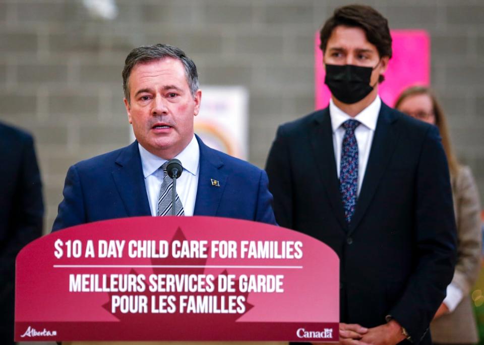 Prime Minister Justin Trudeau, right, looks on as as Alberta Premier Jason Kenney makes a child-care announcement in Edmonton on Nov. 15, 2021.