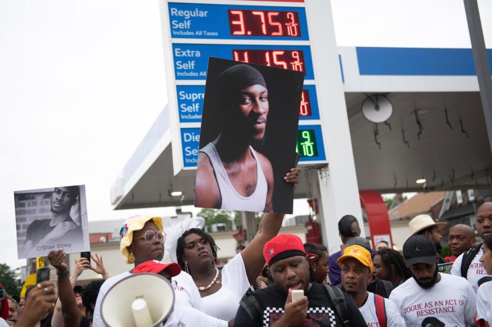 People gather at a gas station in Brooklyn, New York, to pay tribute to O'Shae Sibley (Copyright 2023 The Associated Press. All rights reserved.=copy23==copy23=)