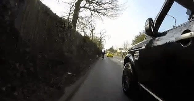 The cyclists helmet camera appears to show a black 4WD trying to overtake him.