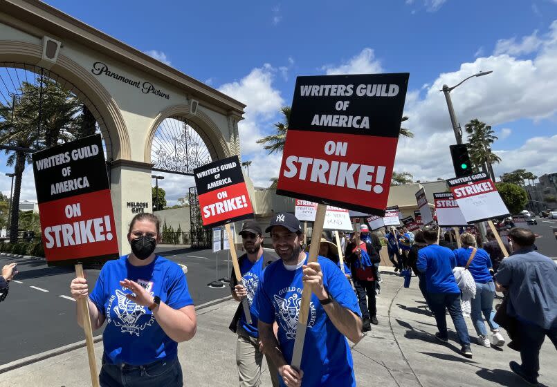 HOLLYWOOD, CA - MAY 2, 2023 - WGA members walk the picket line on the first day of their strike in front of Paramount Studios in Hollywood on May 2, 2023. The union were unable to reach a last minute-accord with the major studios on a new three-year contract to replace one that expired Monday night. (Genaro Molina / Los Angeles Times)