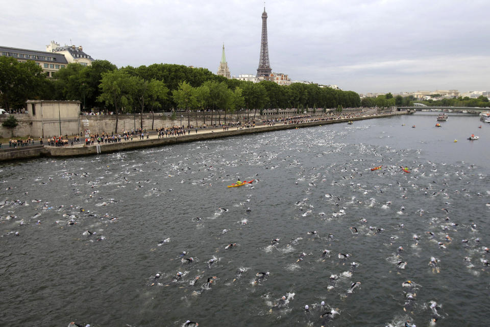 FILE - Competitors swim in the Seine River during the Paris Triathlon competition in Paris Sunday, July 10, 2011. Paris mayor Anne Hidalgo saidTuesday April 23, 2024 she was confident water quality will be up to the Olympics standards this summer _ and that she'll be able to prove it by swimming there, possibly alongside President Emmanuel Macron. (AP Photo/Lionel Cironneau, File )