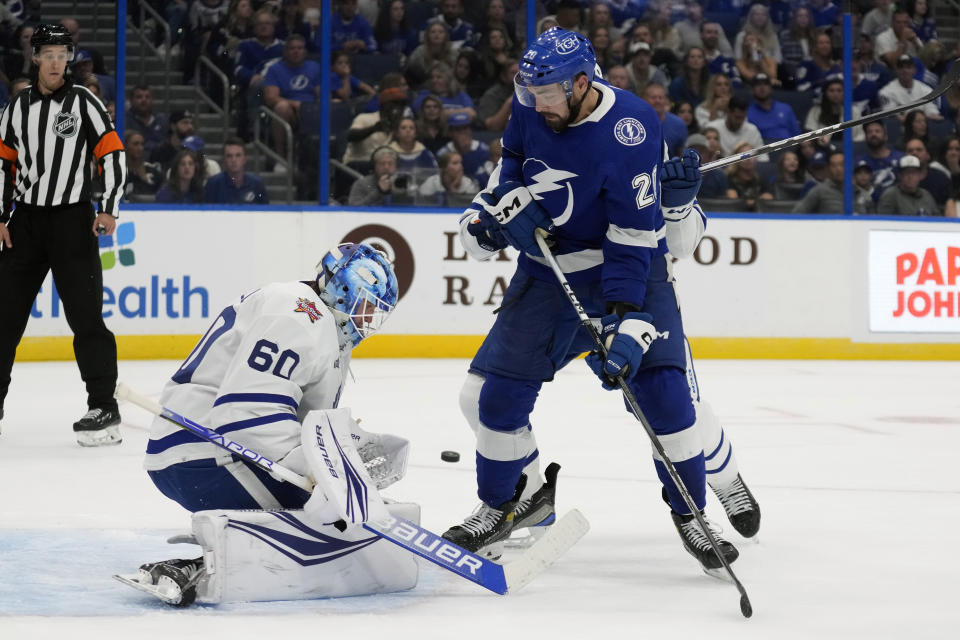 Toronto Maple Leafs goaltender Joseph Woll (60) makes a save on a shot by Tampa Bay Lightning left wing Nick Paul (20) during the second period of an NHL hockey game Saturday, Oct. 21, 2023, in Tampa, Fla. (AP Photo/Chris O'Meara)